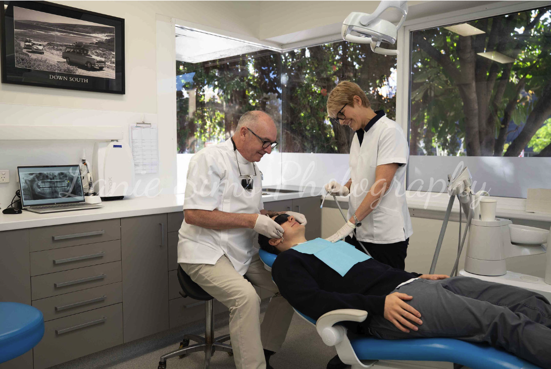 Dr Lego and assistant treating a patient